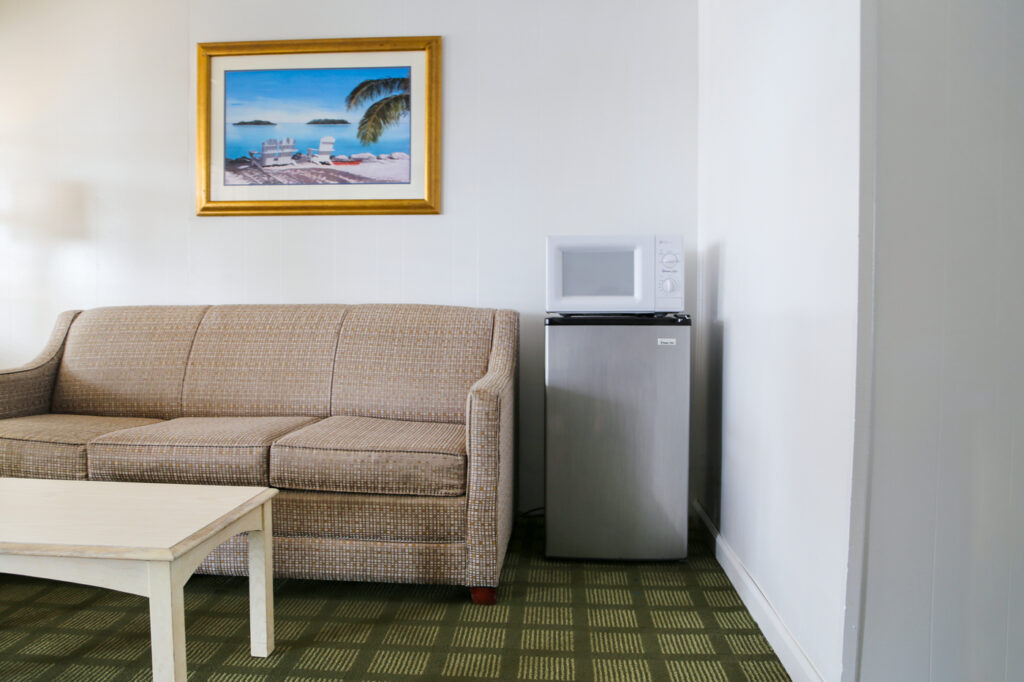 sofa and mini-fridge in motel